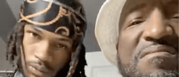 Two men wearing hats, close-up.
